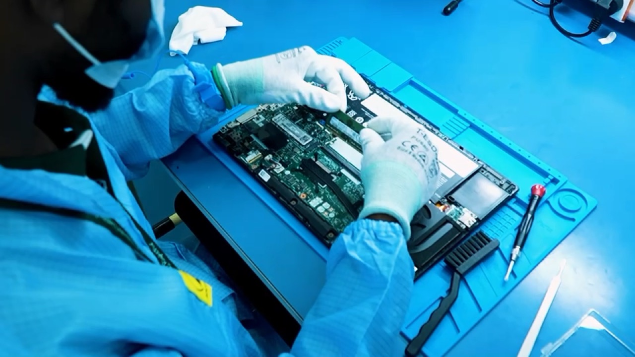 Technicians at anti-static benches in the RightFix Labs repair clean room
